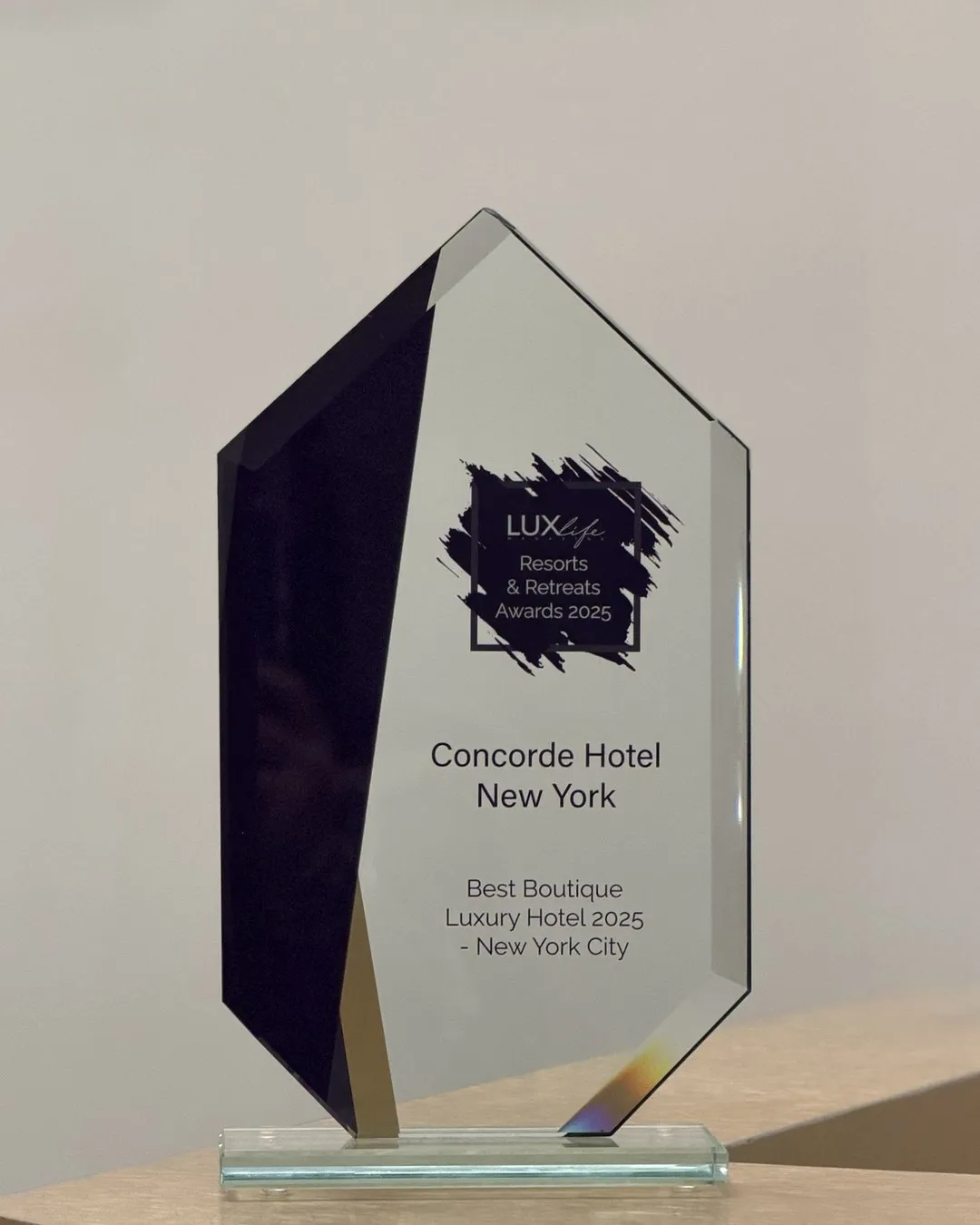 A glass award engraved for Concorde Hotel New York, Best Boutique Luxury Hotel, New York City